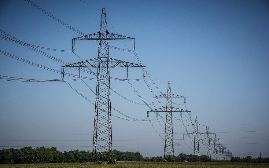 several power transmission lines against a clear blue sky background