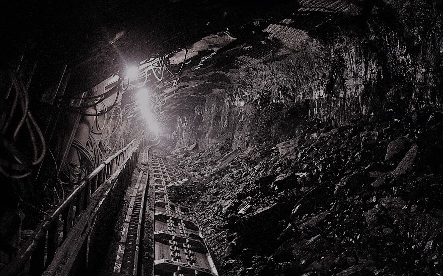 greyscale image inside a pit of a coal mine